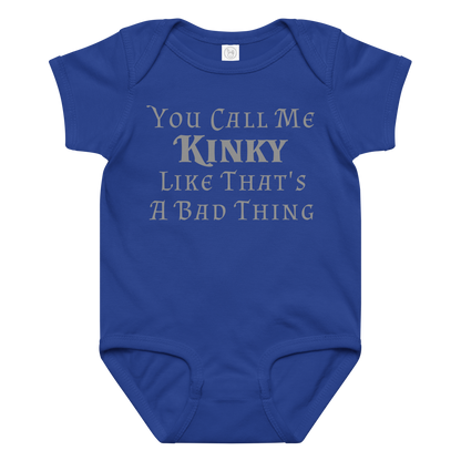 "You Call Me Kinky Like That's A Bad Thing" printed on a royal baby jersey bodysuit laying on a flat surface amongst other clothes