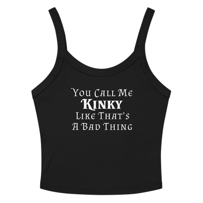 "You Call Me Kinky Like That's A Bad Thing" printed on a solid black blend women's micro-rib tanktop laying on a flat surface amongst sunglasses and shorts