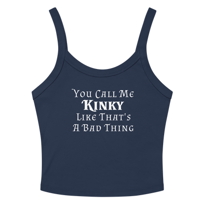 "You Call Me Kinky Like That's A Bad Thing" printed on a solid navy blend women's micro-rib tanktop laying on a flat surface amongst sunglasses and shorts