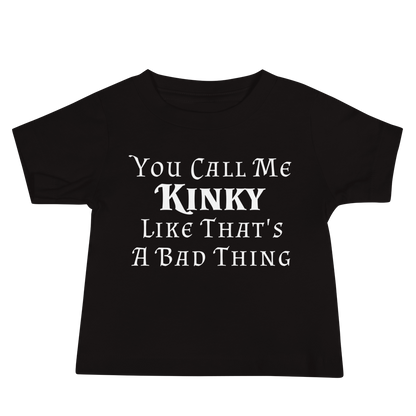 "You Call Me Kinky Like That's A Bad Thing" printed on a black baby jersey short sleeve tee laying on a flat surface