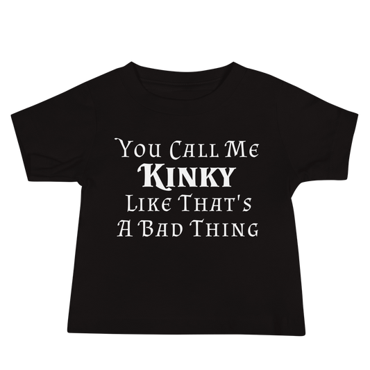 "You Call Me Kinky Like That's A Bad Thing" printed on a black baby jersey short sleeve tee laying on a flat surface