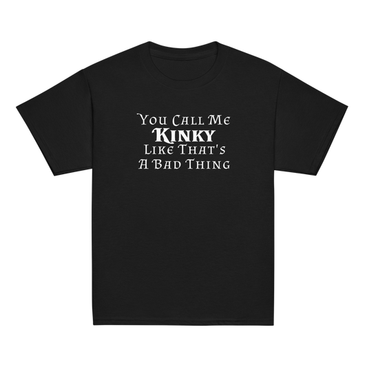 "You Call Me Kinky Like That's A Bad Thing" printed on a black youth classic tee laying on a flat surface