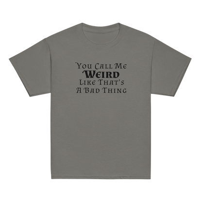 "You Call Me Weird Like That's A Bad Thing" printed on a charcoal youth classic tee laying on a flat surface