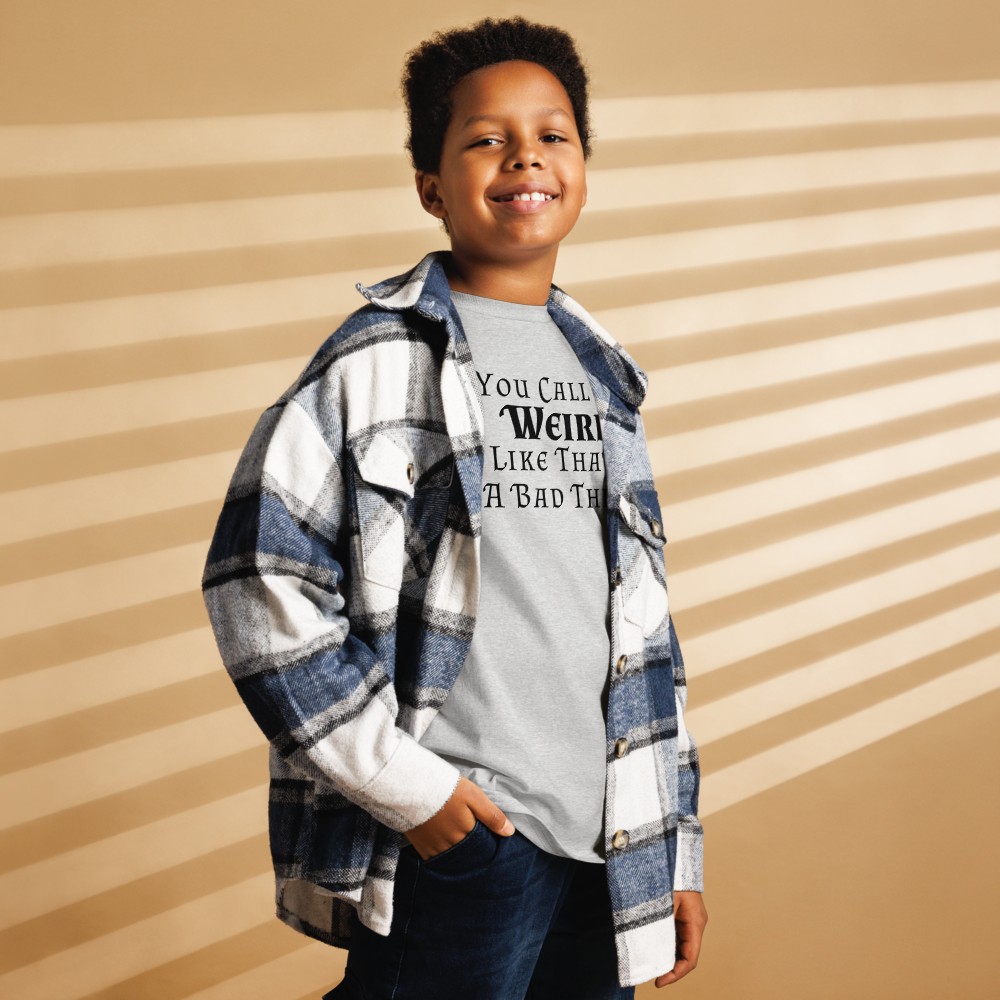 "You Call Me Weird Like That's A Bad Thing" printed on a sport grey youth classic tee worn by a male also wearing a jacket