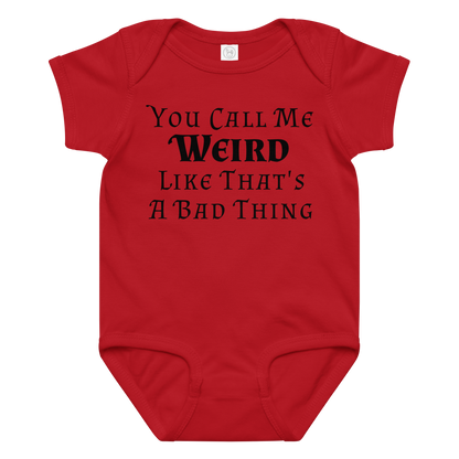 "You Call Me Weird Like That's A Bad Thing" printed on a red baby jersey bodysuit laying on a flat surface amongst other clothes