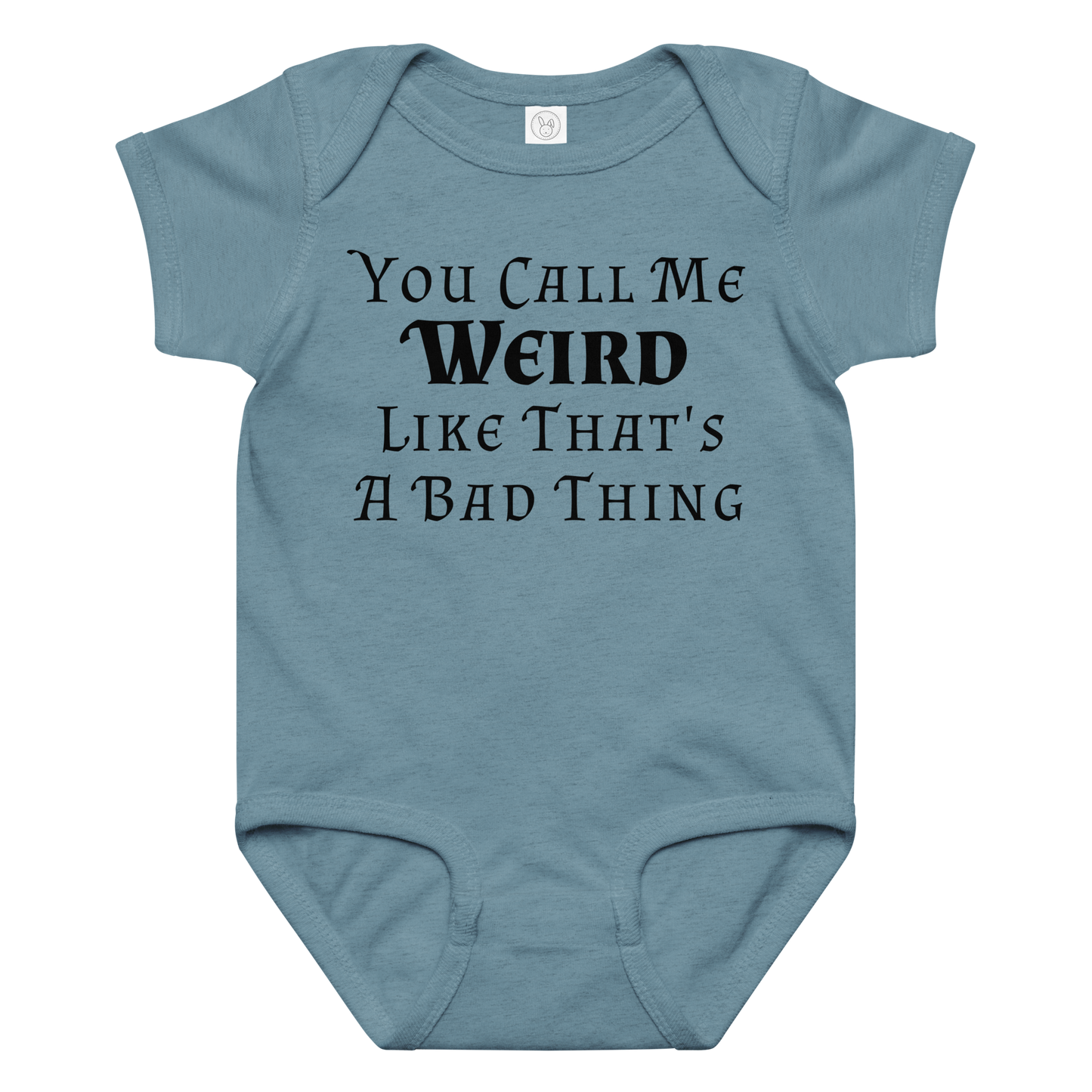 "You Call Me Weird Like That's A Bad Thing" printed on a vintage indigo baby jersey bodysuit laying on a flat surface amongst other clothes