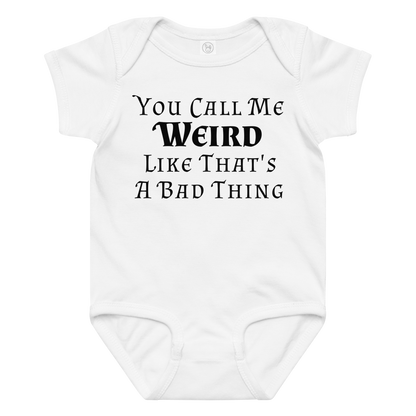 "You Call Me Weird Like That's A Bad Thing" printed on a white baby jersey bodysuit laying on a flat surface amongst other clothes