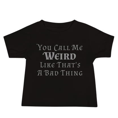 "You Call Me Weird Like That's A Bad Thing" printed on a black baby jersey short sleeve tee laying on a flat surface