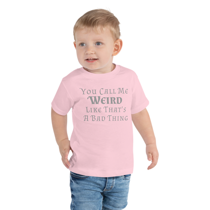 "You Call Me Weird Like That's A Bad Thing" printed on a pink toddler short sleeve tee worn by a male