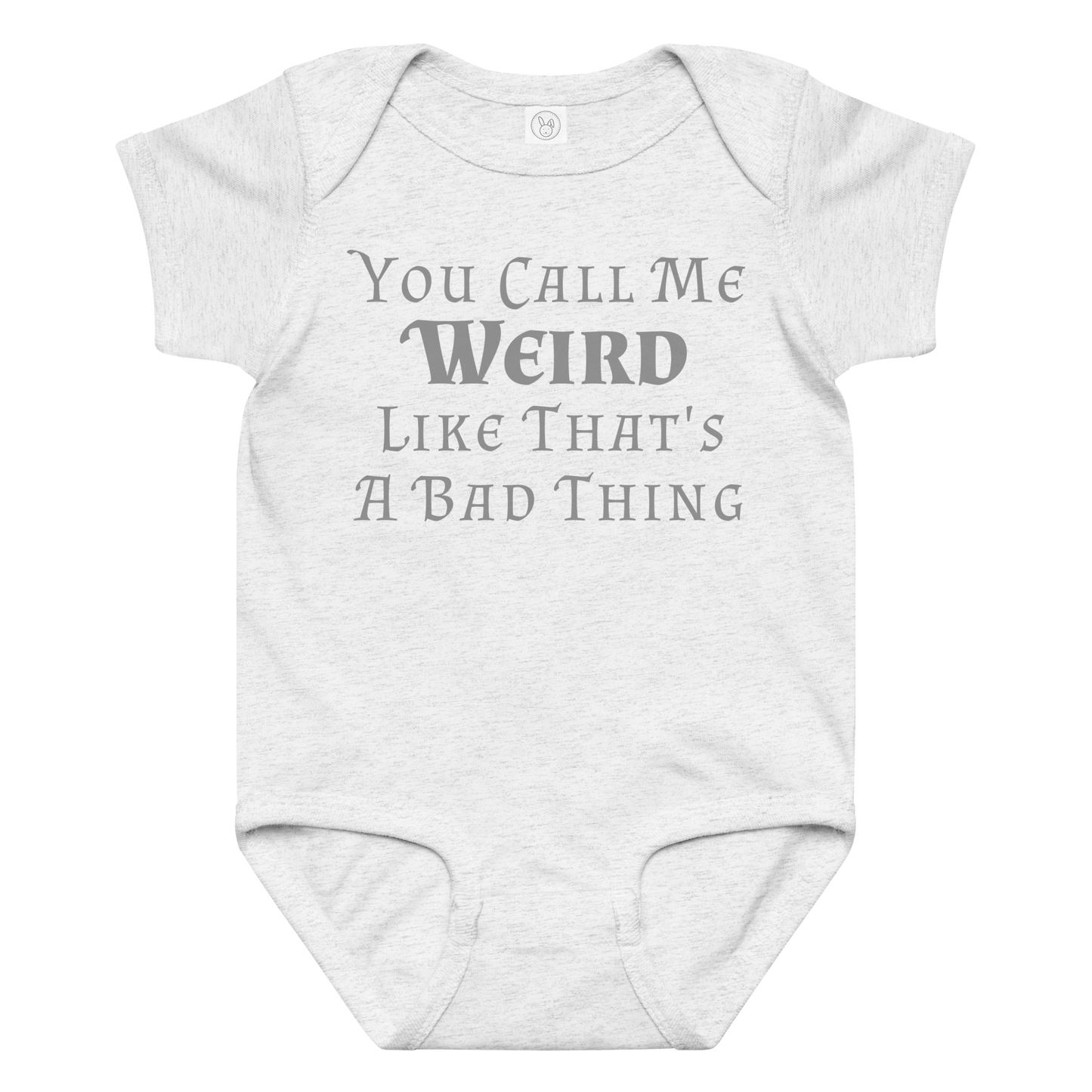 "You Call Me Weird Like That's A Bad Thing" printed on a ash baby jersey bodysuit laying on a flat surface amongst other clothes