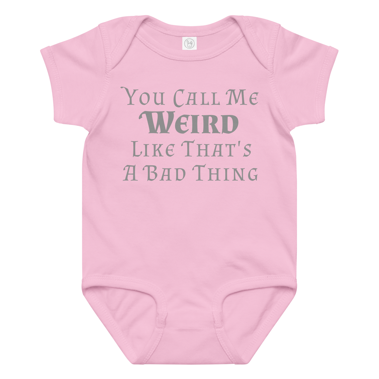 "You Call Me Weird Like That's A Bad Thing" printed on a pink baby jersey bodysuit laying on a flat surface amongst other clothes