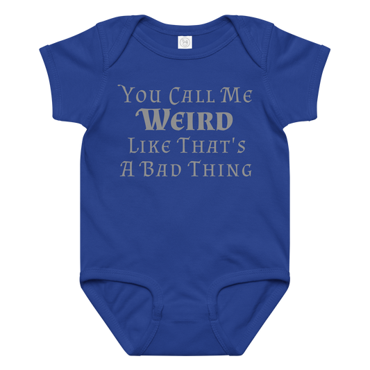 "You Call Me Weird Like That's A Bad Thing" printed on a royal baby jersey bodysuit laying on a flat surface amongst other clothes