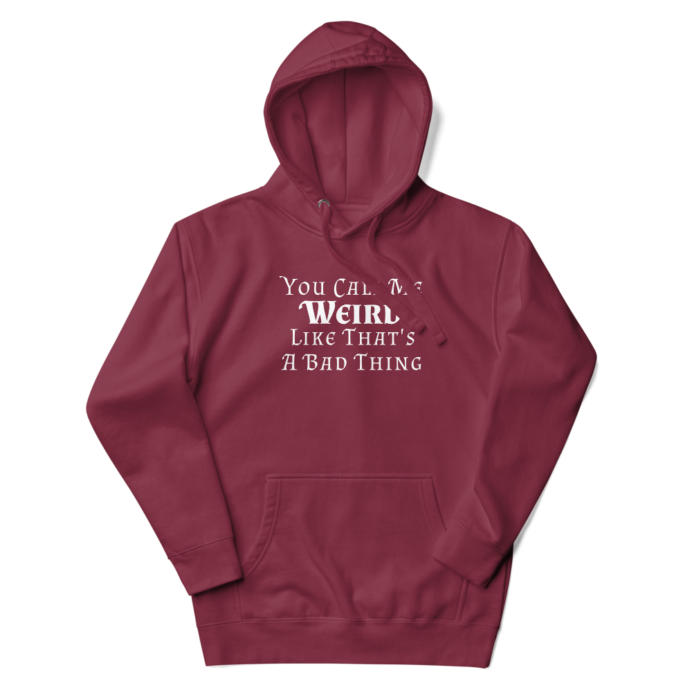 "You Call Me Weird Like That's A Bad Thing" printed on a maroon unisex hoodie laying on a flat surface with the hood up
