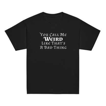 "You Call Me Weird Like That's A Bad Thing" printed on a black youth classic tee laying on a flat surface