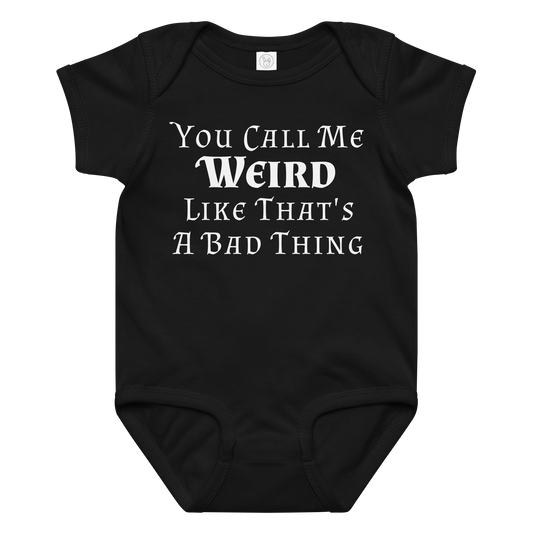 "You Call Me Weird Like That's A Bad Thing" printed on a black baby jersey bodysuit laying on a flat surface amongst other clothes