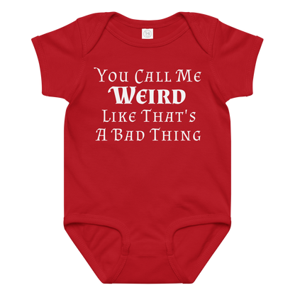 "You Call Me Weird Like That's A Bad Thing" printed on a red baby jersey bodysuit laying on a flat surface amongst other clothes