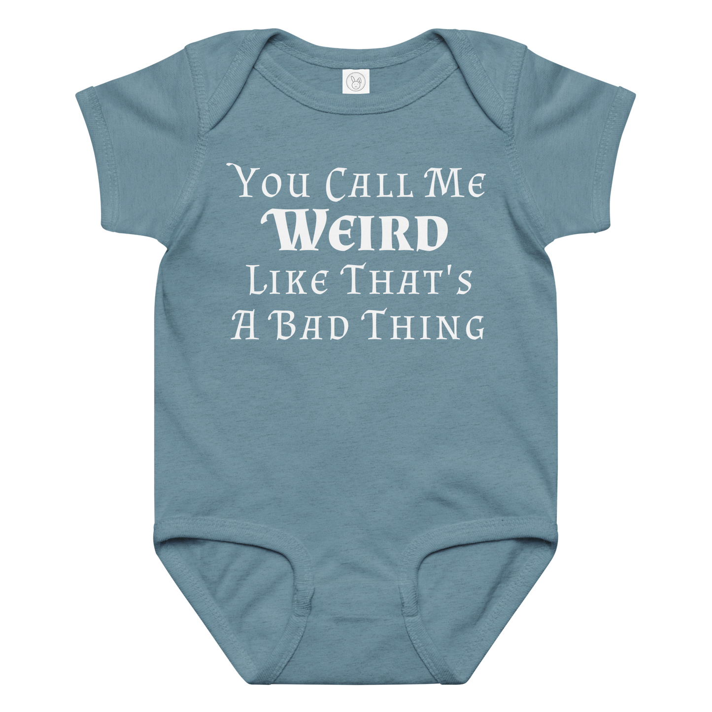 "You Call Me Weird Like That's A Bad Thing" printed on a vintage indigo baby jersey bodysuit laying on a flat surface amongst other clothes