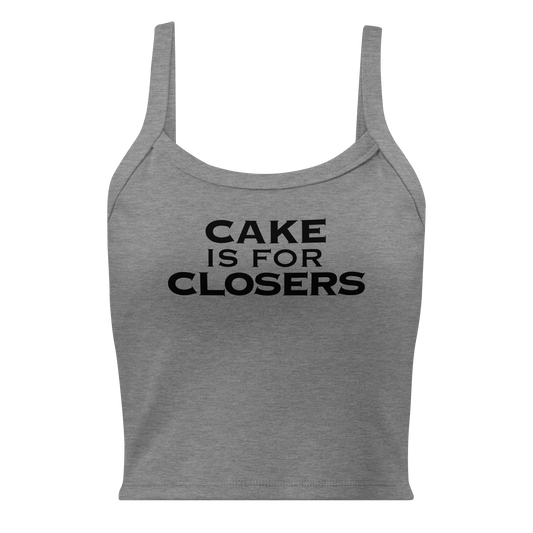 "Cake Is For Closers" printed on a athletic heather women's micro-rib tanktop laying on a flat surface