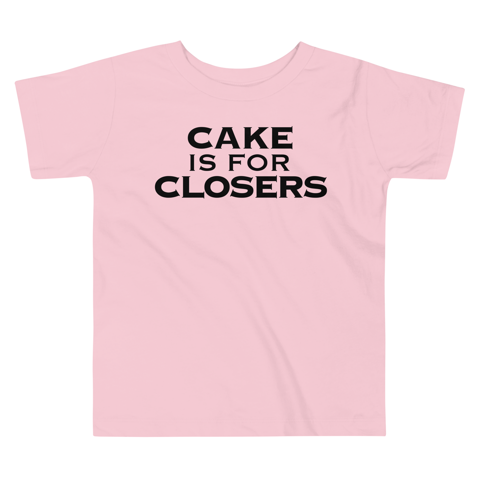 "Cake Is For Closers" printed on a pink toddler short sleeve tee laying on a flat surface