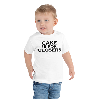 "Cake Is For Closers" printed on a white toddler short sleeve tee worn by a male