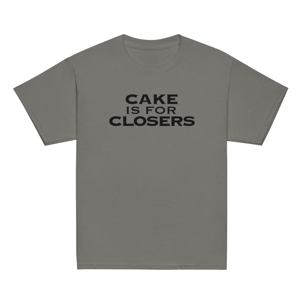 "Cake Is For Closers" printed on a charcoal youth classic tee laying on a flat surface