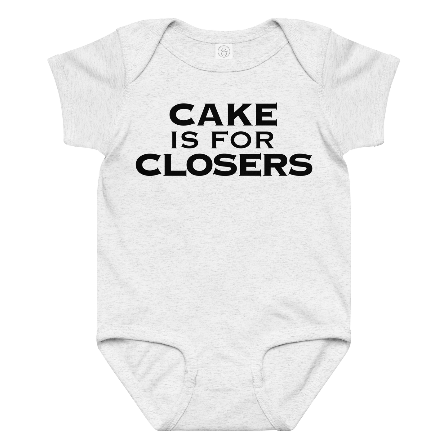 "Cake Is For Closers" printed on a ash baby jersey bodysuit laying on a flat surface amongst other clothes