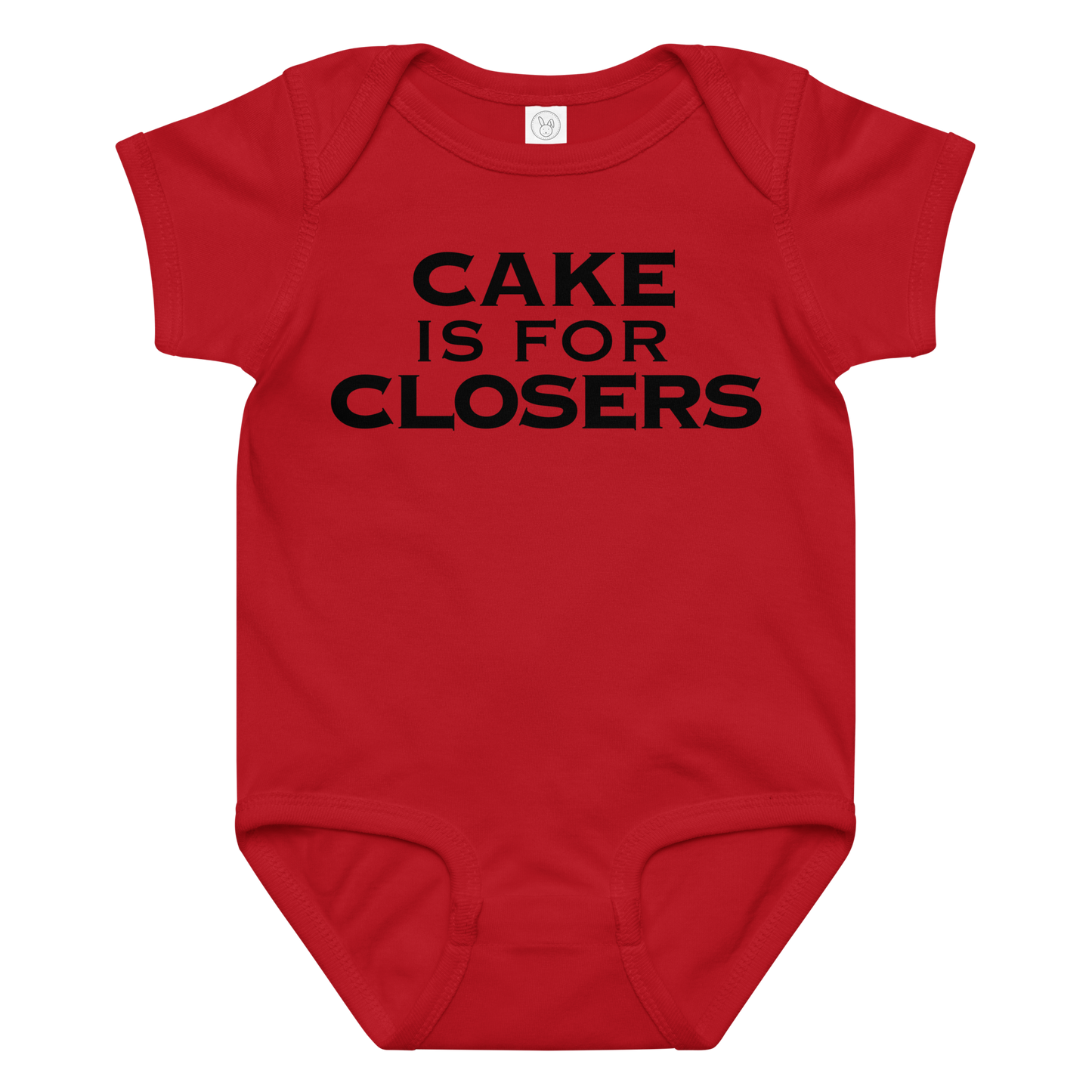 "Cake Is For Closers" printed on a red baby jersey bodysuit laying on a flat surface amongst other clothes