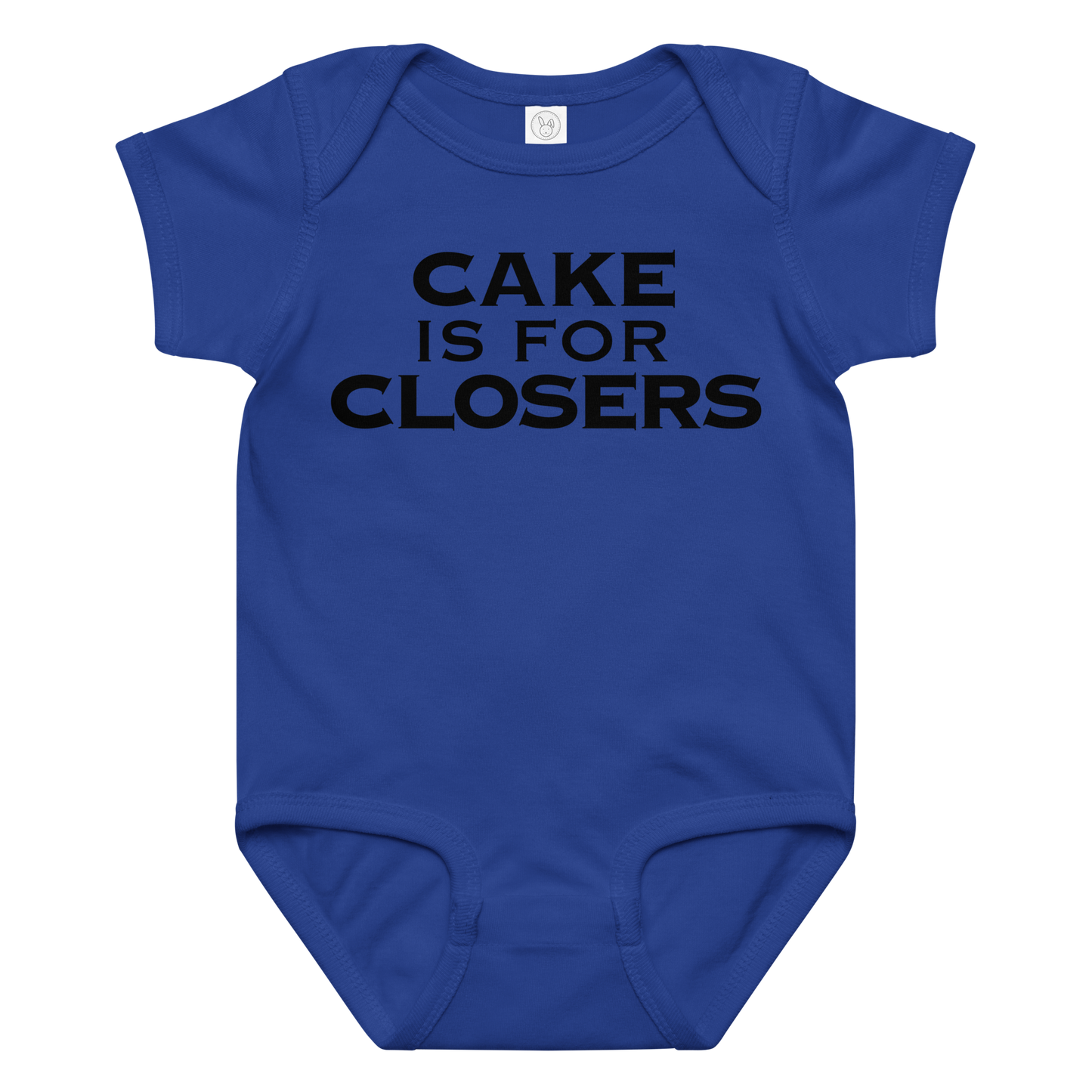 "Cake Is For Closers" printed on a royal baby jersey bodysuit laying on a flat surface amongst other clothes