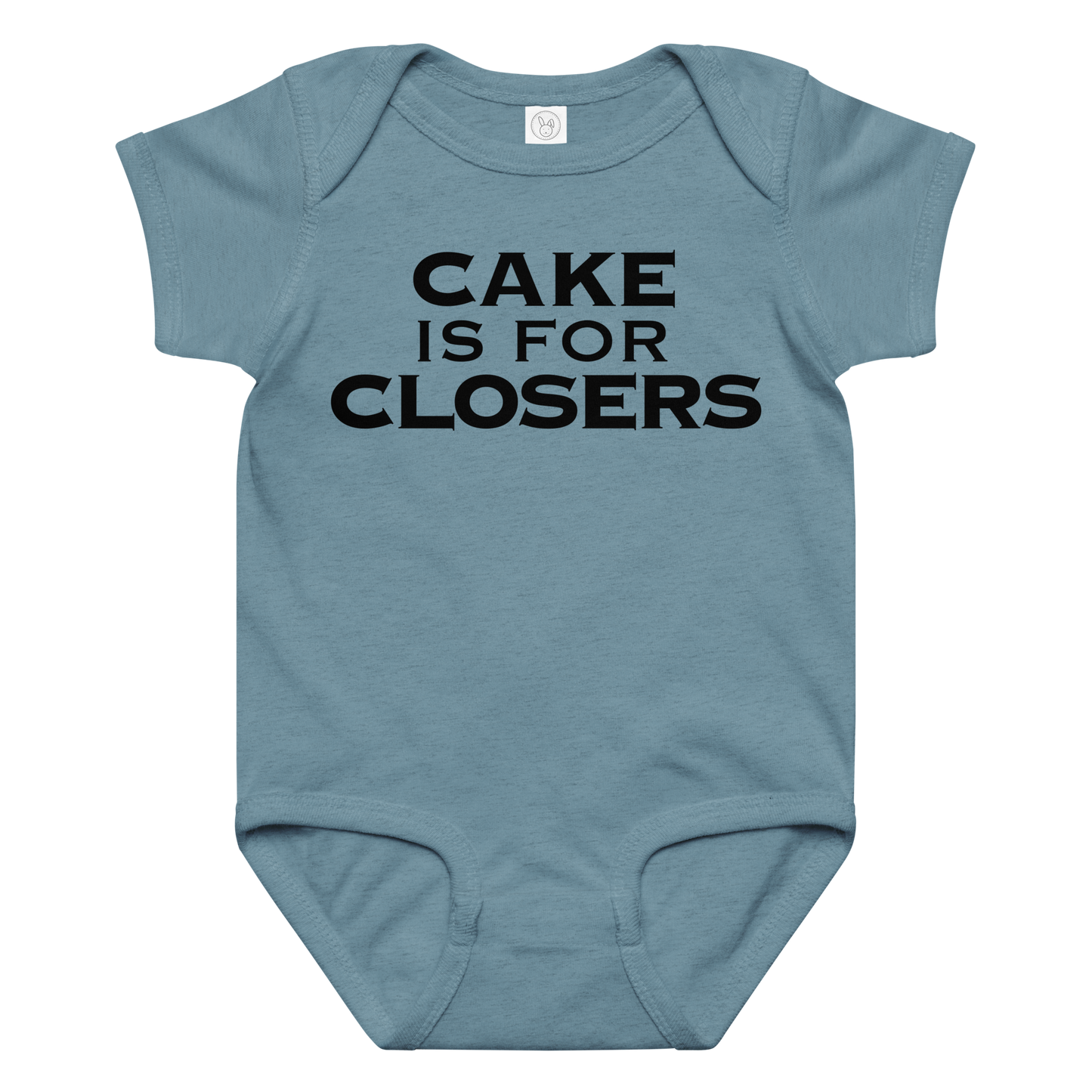 "Cake Is For Closers" printed on a vintage indigo baby jersey bodysuit laying on a flat surface amongst other clothes