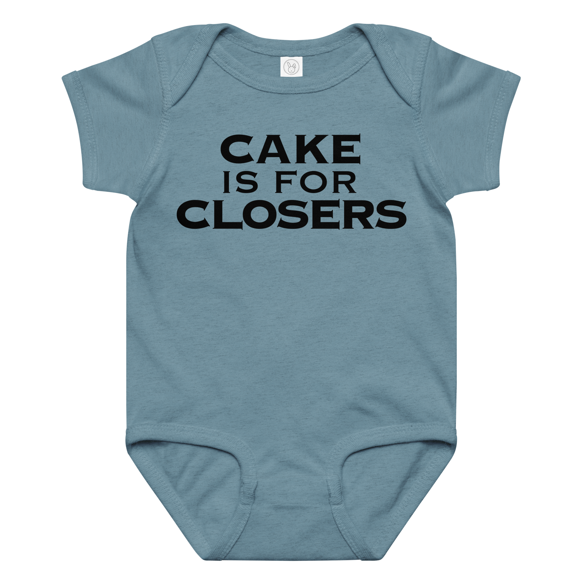 "Cake Is For Closers" printed on a vintage indigo baby jersey bodysuit laying on a flat surface amongst other clothes