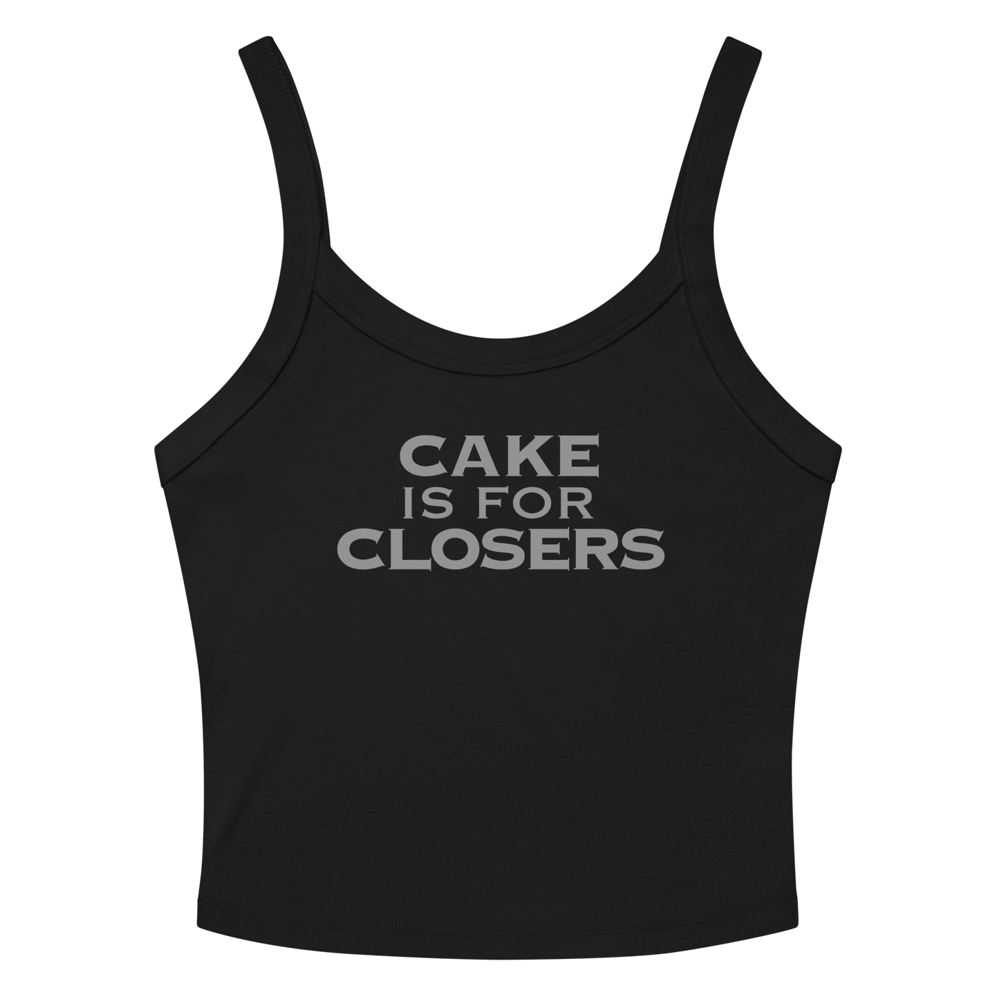 "Cake Is For Closers" printed on a solid black blend women's micro-rib tanktop laying on a flat surface amongst sunglasses and shorts