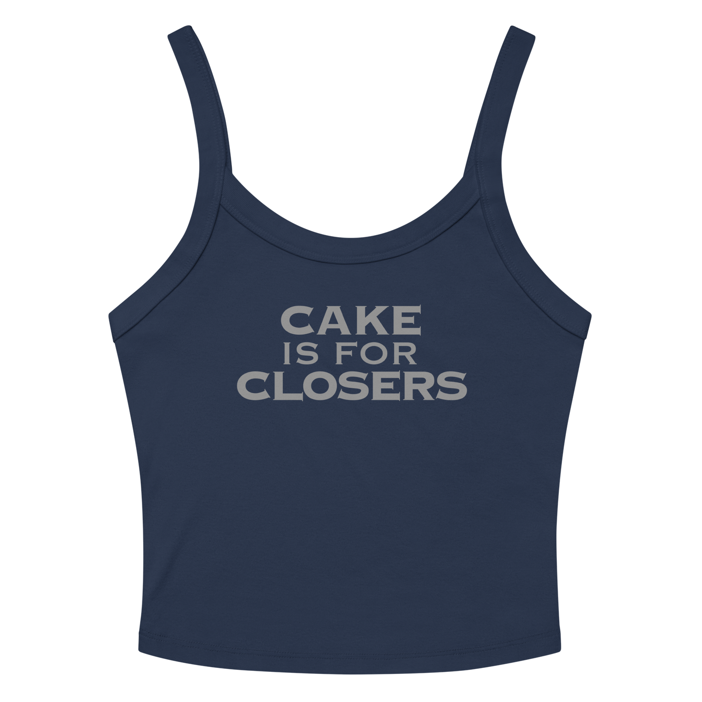 "Cake Is For Closers" printed on a solid navy blend women's micro-rib tanktop laying on a flat surface amongst sunglasses and shorts