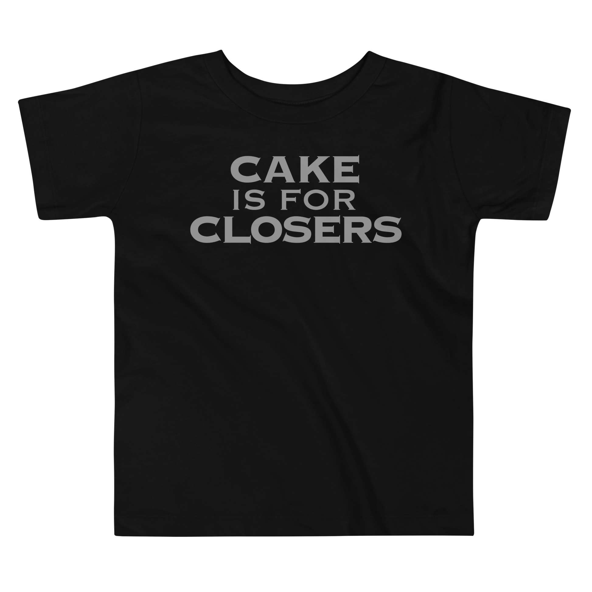 "Cake Is For Closers" printed on a black toddler short sleeve tee laying on a flat surface