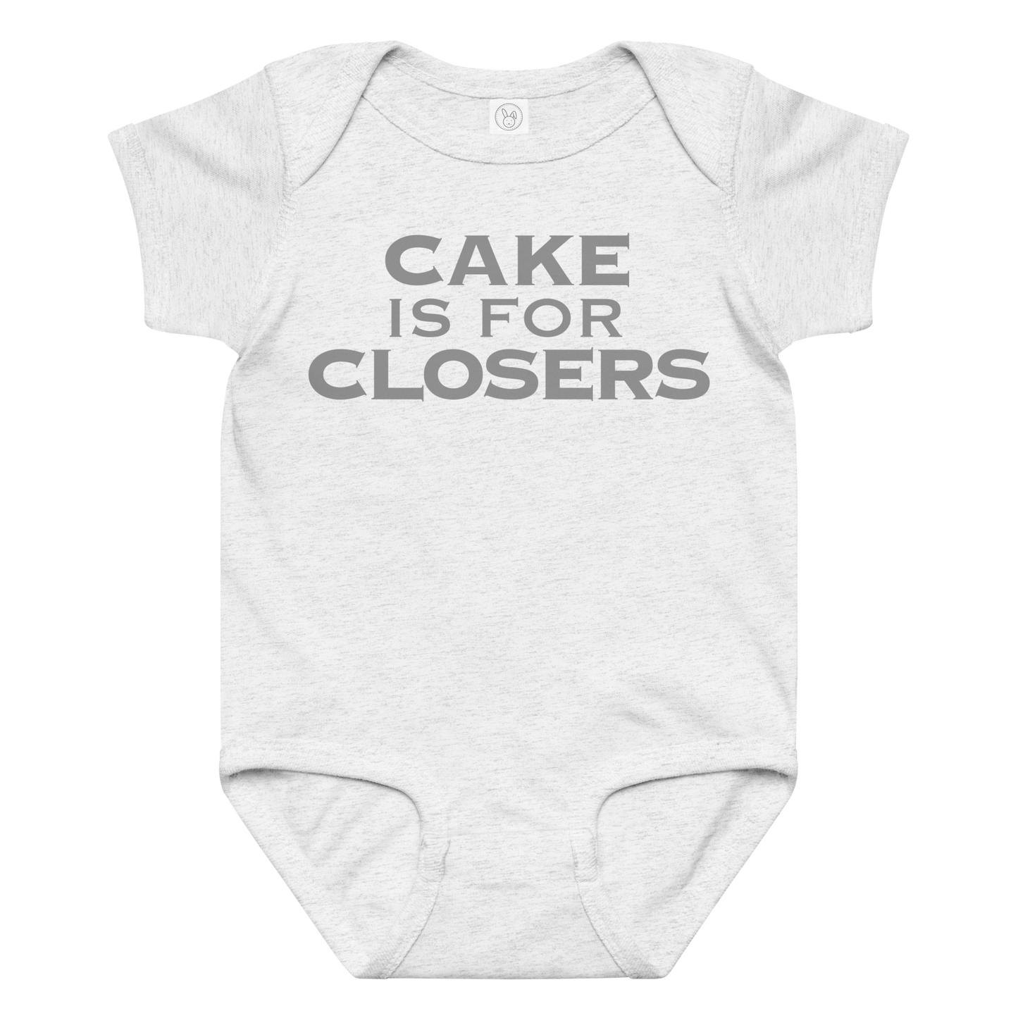 "Cake Is For Closers" printed on a ash baby jersey bodysuit laying on a flat surface amongst other clothes