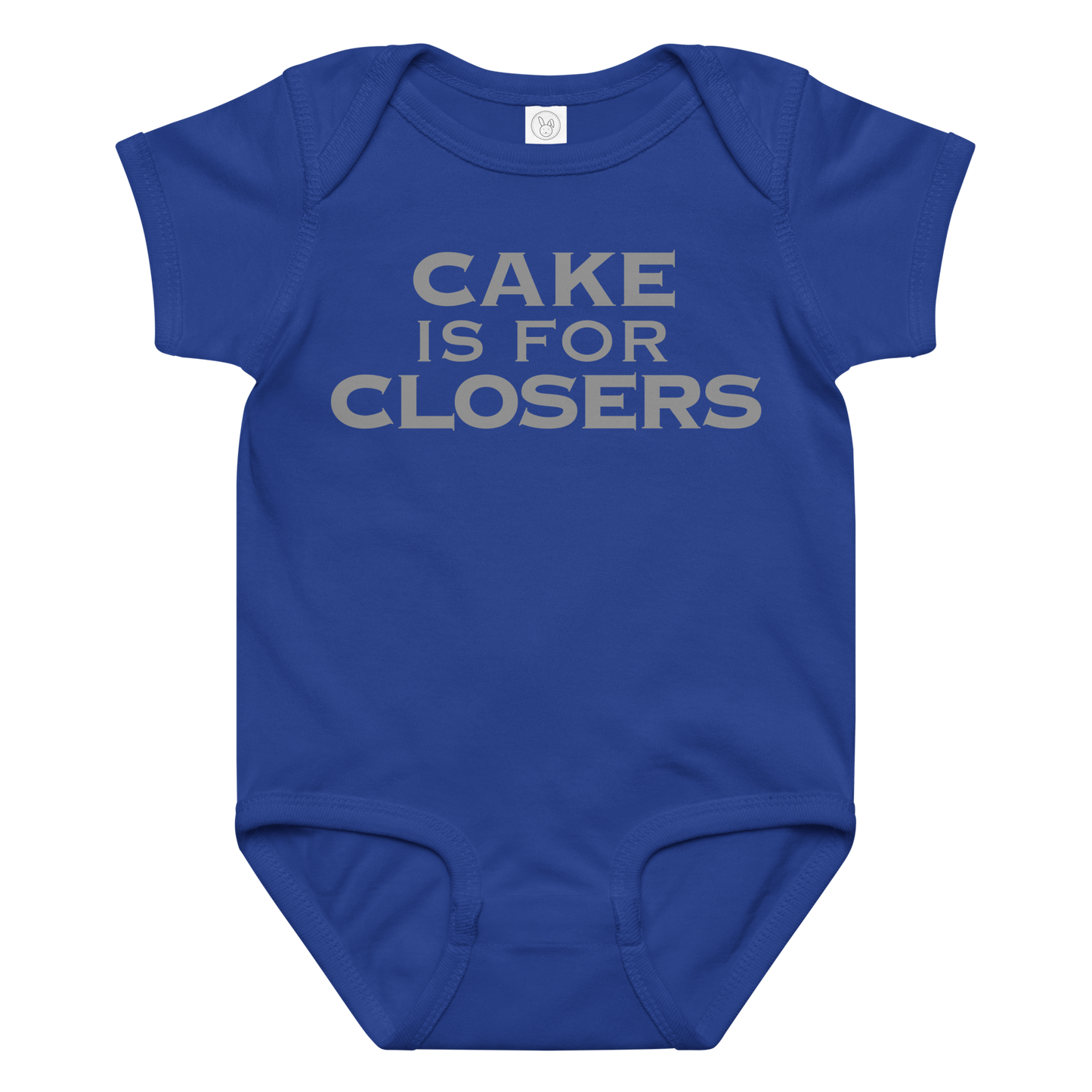 "Cake Is For Closers" printed on a royal baby jersey bodysuit laying on a flat surface amongst other clothes