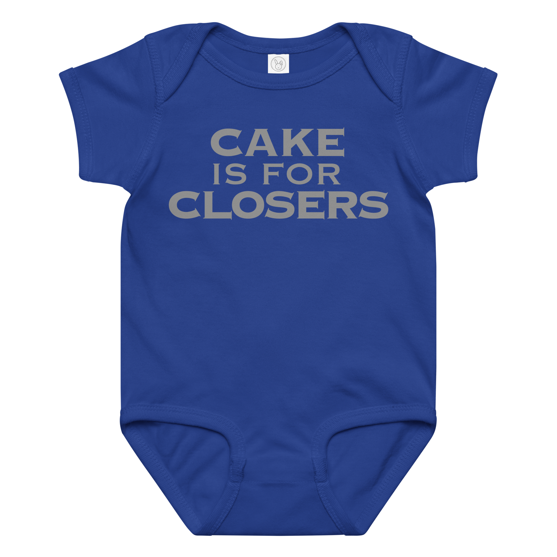 "Cake Is For Closers" printed on a royal baby jersey bodysuit laying on a flat surface amongst other clothes