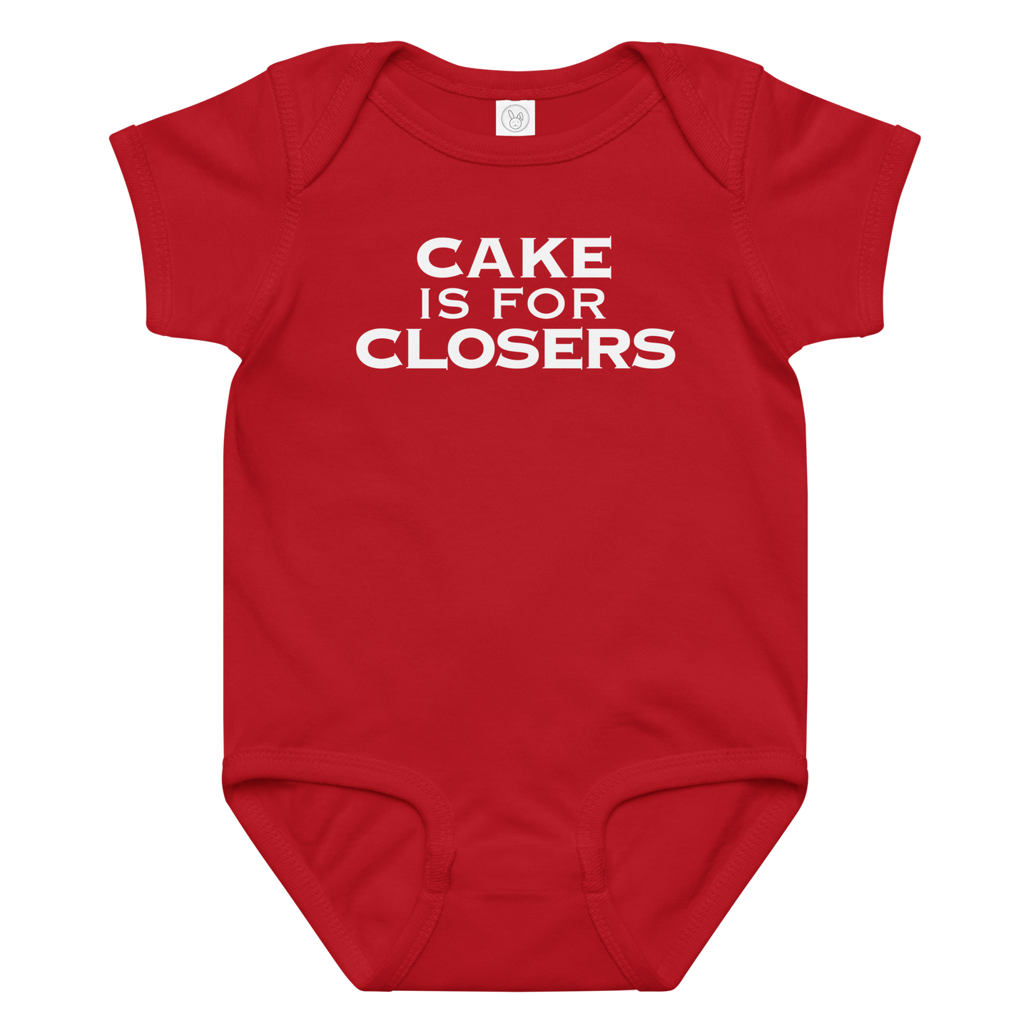 "Cake Is For Closers" printed on a red baby jersey bodysuit laying on a flat surface amongst other clothes