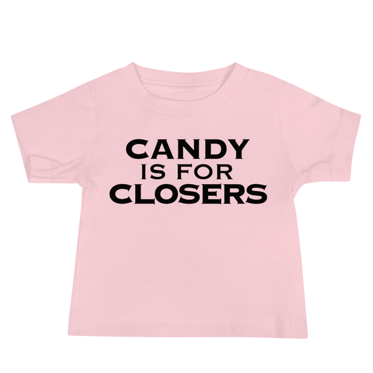 "Candy Is For Closers" printed on a pink baby jersey short sleeve tee laying on a flat surface