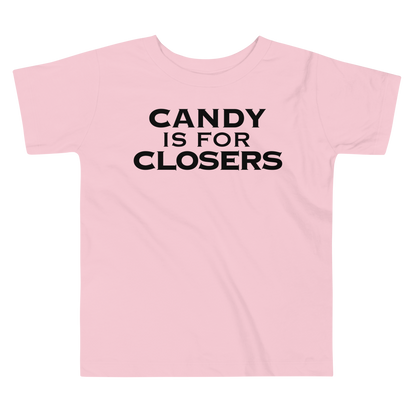 "Candy Is For Closers" printed on a pink toddler short sleeve tee laying on a flat surface