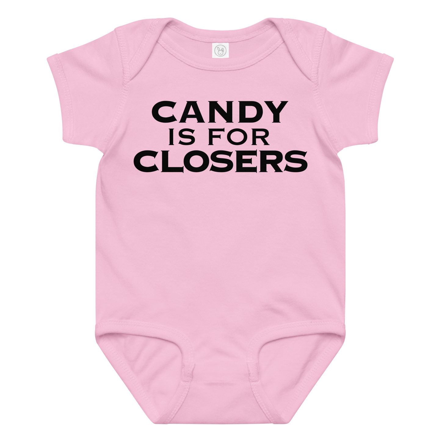 "Candy Is For Closers" printed on a pink baby jersey bodysuit laying on a flat surface amongst other clothes