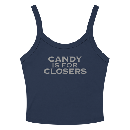 "Candy Is For Closers" printed on a solid navy blend women's micro-rib tanktop laying on a flat surface amongst sunglasses and shorts
