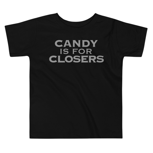 "Candy Is For Closers" printed on a black toddler short sleeve tee laying on a flat surface