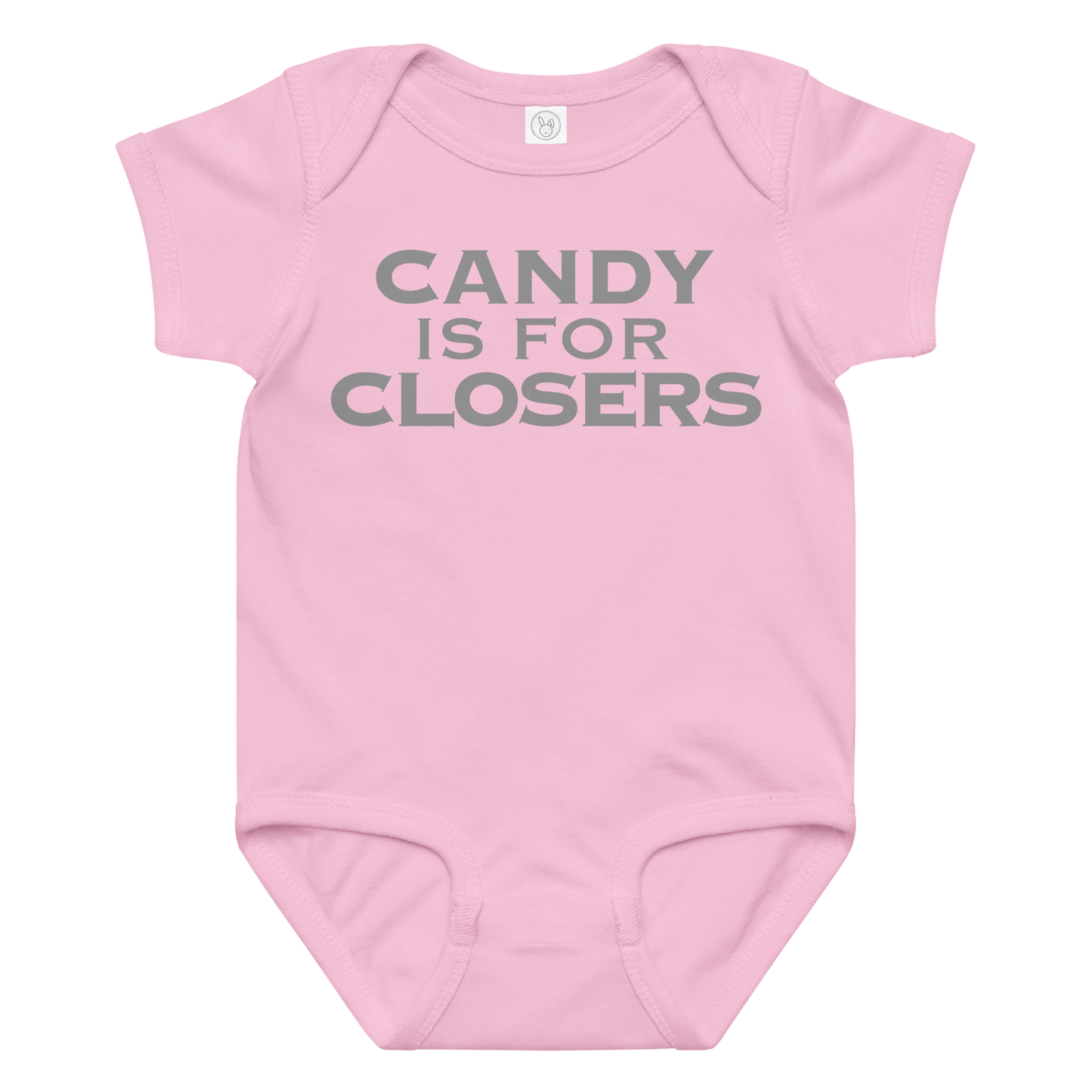 "Candy Is For Closers" printed on a pink baby jersey bodysuit laying on a flat surface amongst other clothes