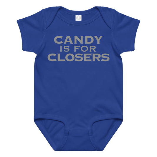 "Candy Is For Closers" printed on a royal baby jersey bodysuit laying on a flat surface amongst other clothes