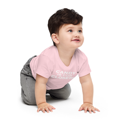 "Candy Is For Closers" printed on a pink baby jersey short sleeve tee worn by a male who is crawling