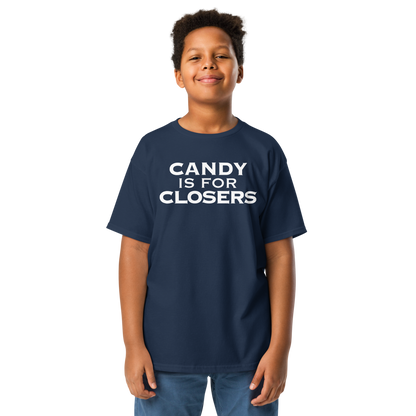 "Candy Is For Closers" printed on a navy youth classic tee worn by a male