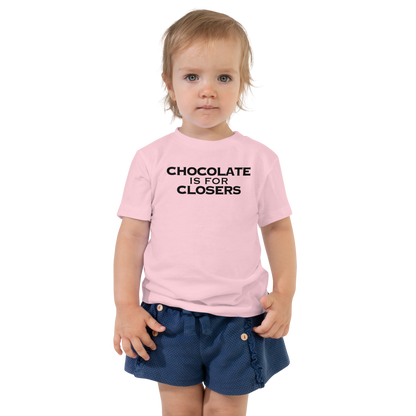 "Chocolate Is For Closers" printed on a pink toddler short sleeve tee worn by a female