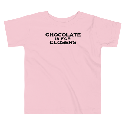 "Chocolate Is For Closers" printed on a pink toddler short sleeve tee laying on a flat surface