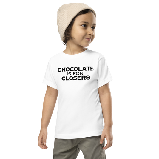"Chocolate Is For Closers" printed on a white toddler short sleeve tee worn by a male wearing a cap