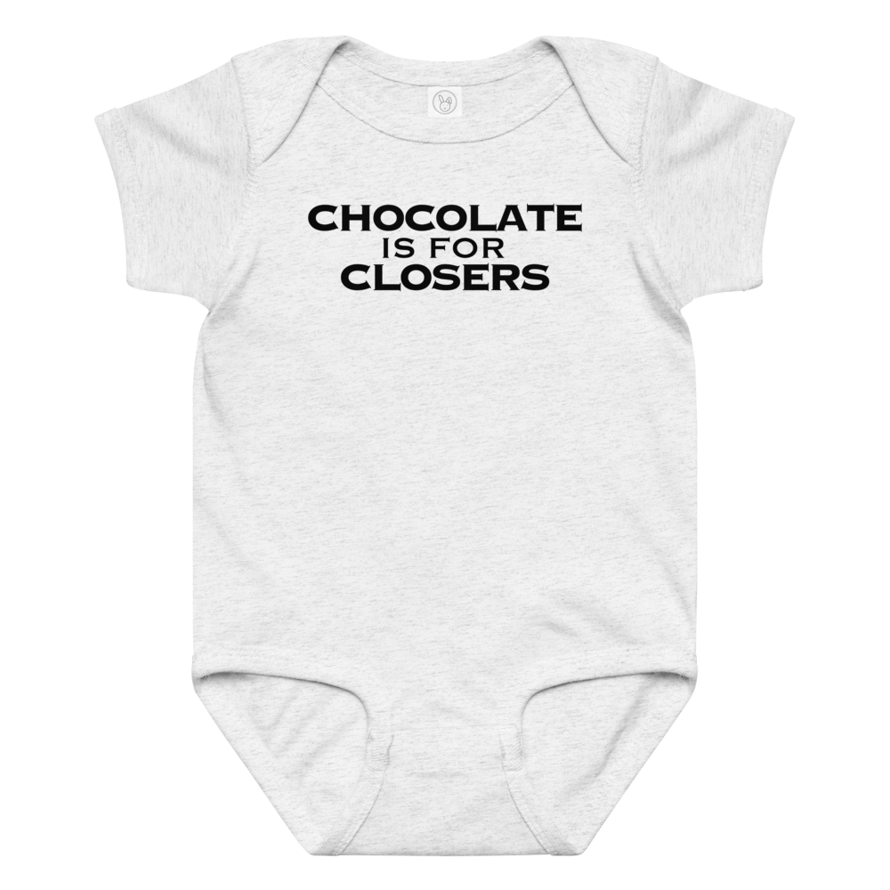 "Chocolate Is For Closers" printed on a ash baby jersey bodysuit laying on a flat surface amongst other clothes